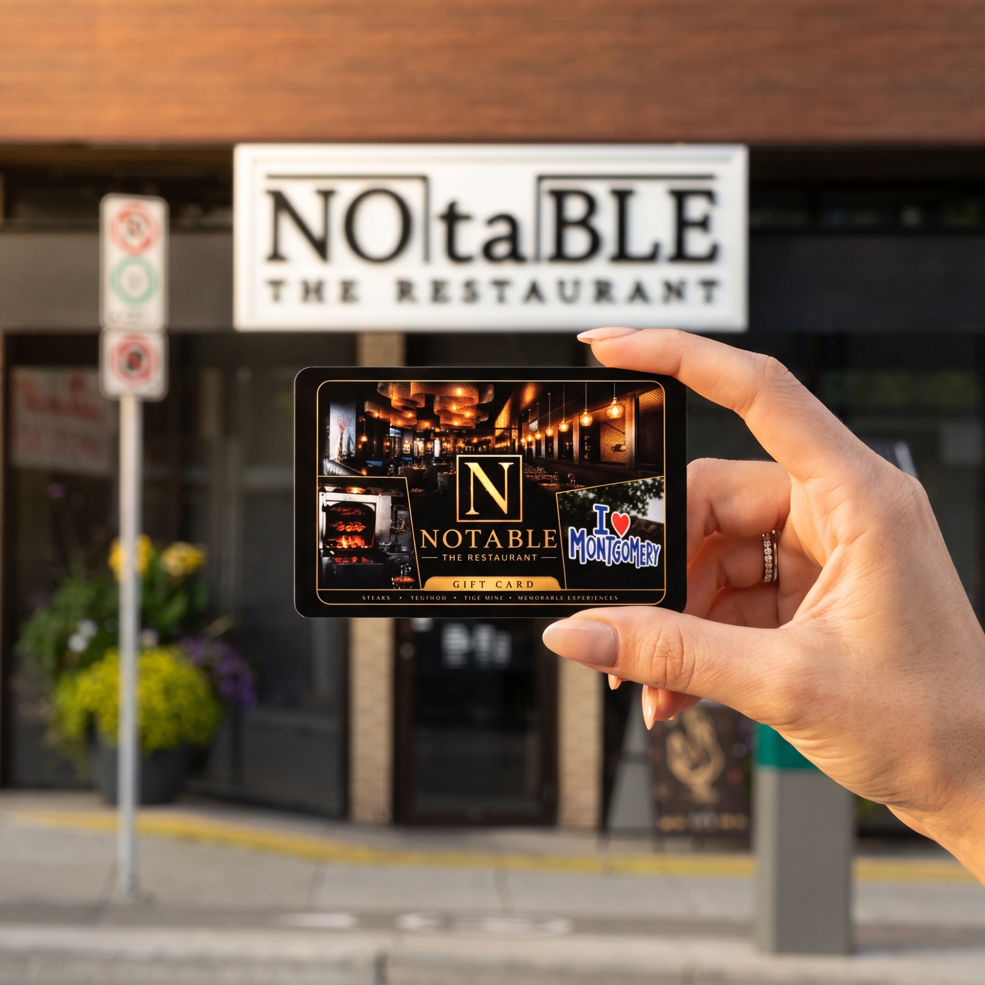 A NOTABLE - The Steakhouse gift card held up in front of the restaurant on Bowness Road NW, Calgary
